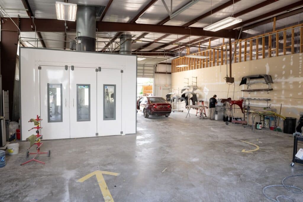 Active shop floor with multiple vehicles being worked on